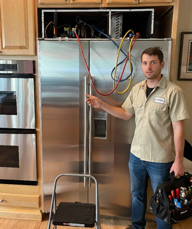 Technician servicing sealed refrigerant system on Sub-Zero built-in